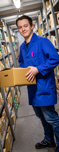 LAEPPCHÉ employee in blue suit in the shipping hall between shelves